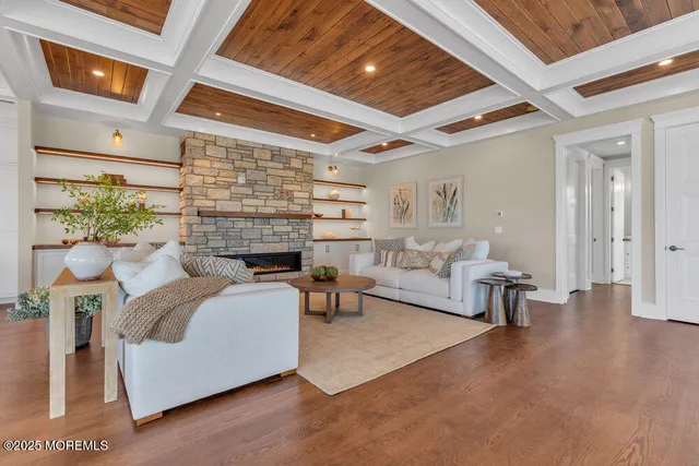 a large white kitchen with stainless steel appliances granite countertop a stove and a sink