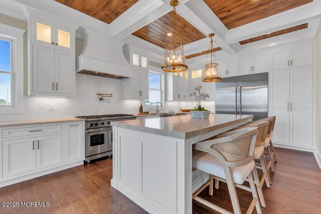 a kitchen with a stove and white cabinets