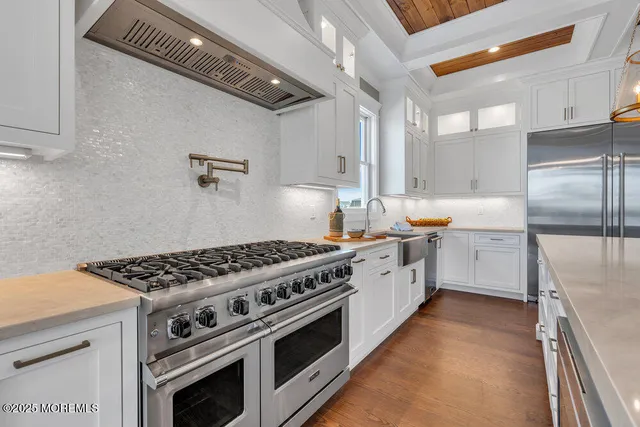 a view of a dining room with furniture a chandelier and wooden floor