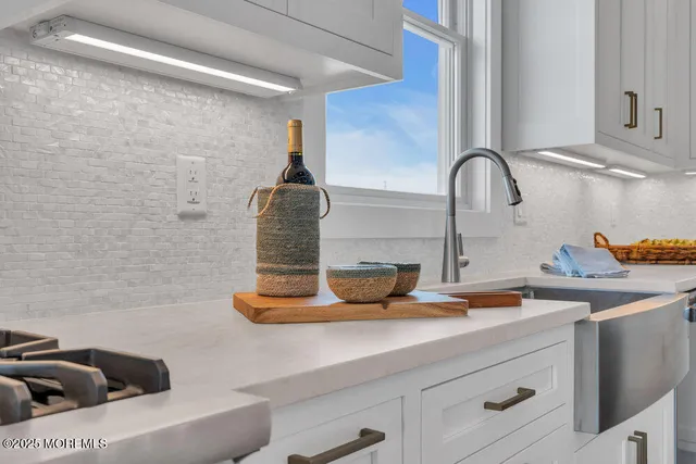 a view of a room with a ceiling fan and window