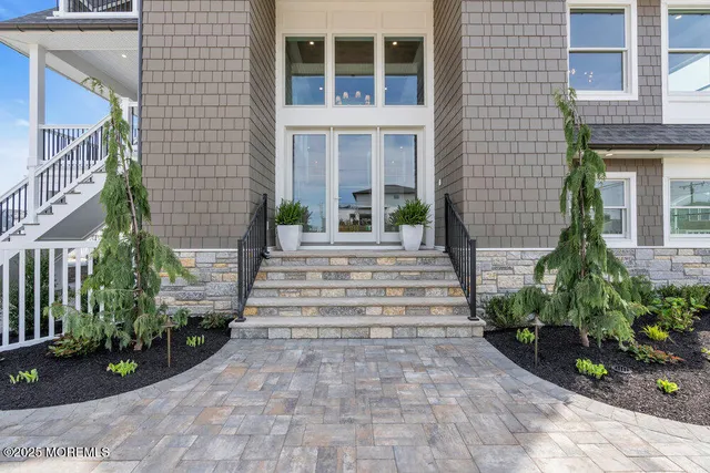 a view of staircase with wooden floor and white walls