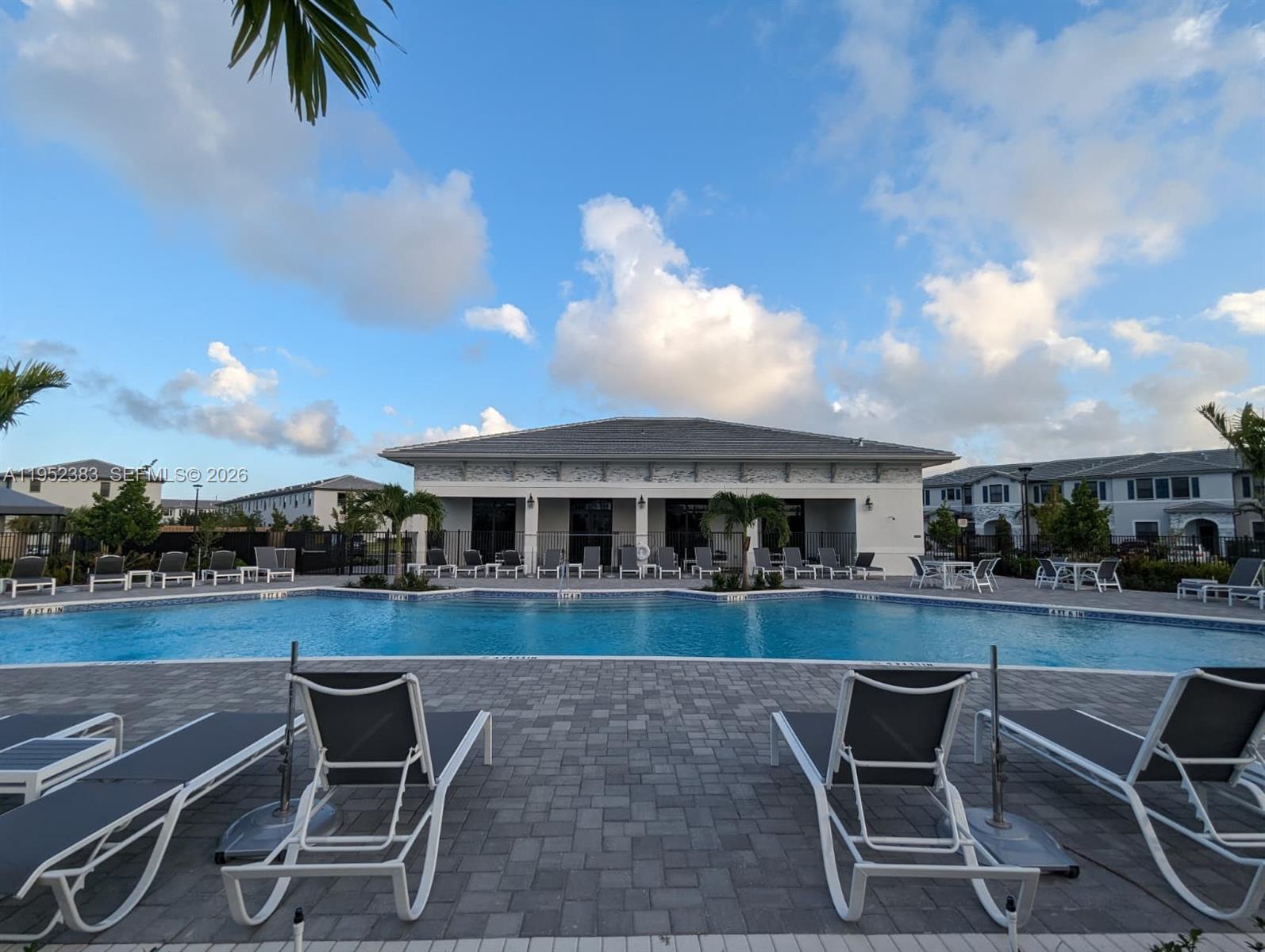 a view of a patio with table and chairs with wooden floor and fence