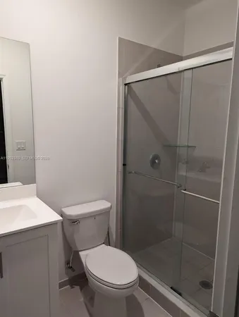 a white toilet sitting next to a bathroom sink