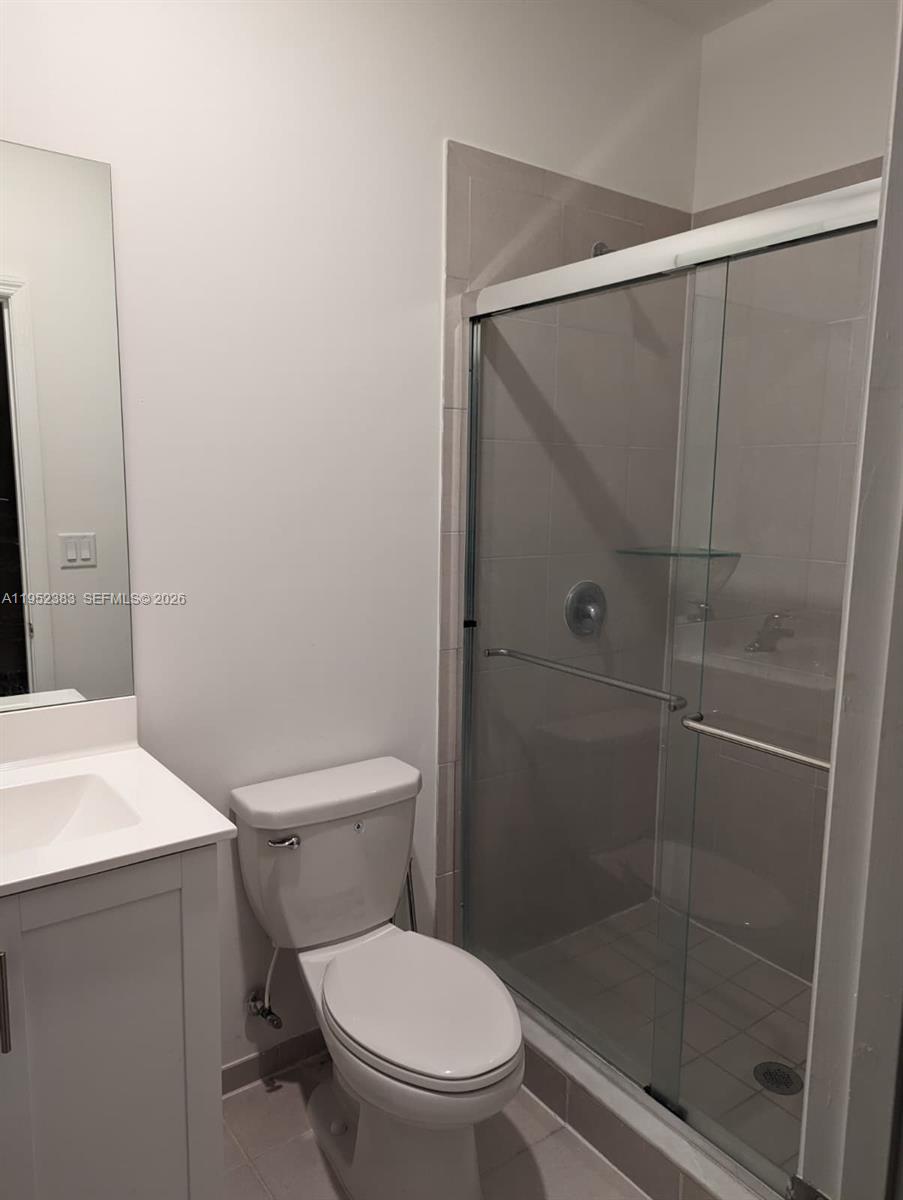 28661 Southwest 132nd Place Homestead, FL 33033 - Photo 14 of 16 a white toilet sitting next to a bathroom sink