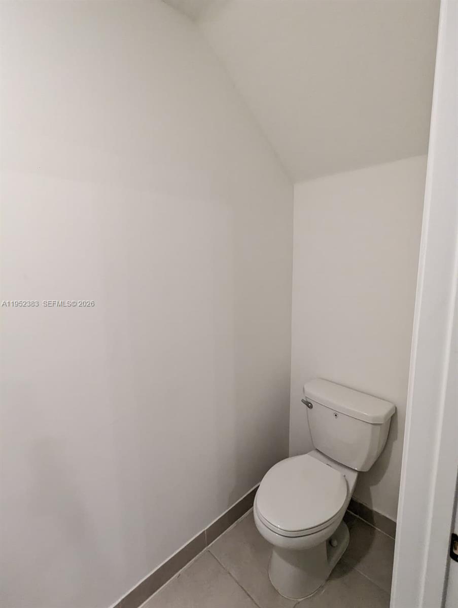 28661 Southwest 132nd Place Homestead, FL 33033 - Photo 7 of 16 a white toilet sitting next to a white wall