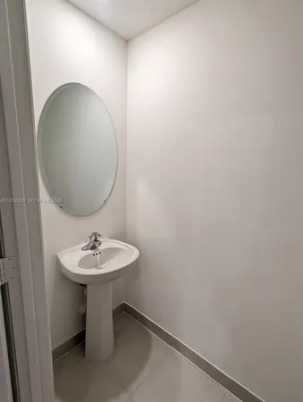 a bathroom with a sink and mirror