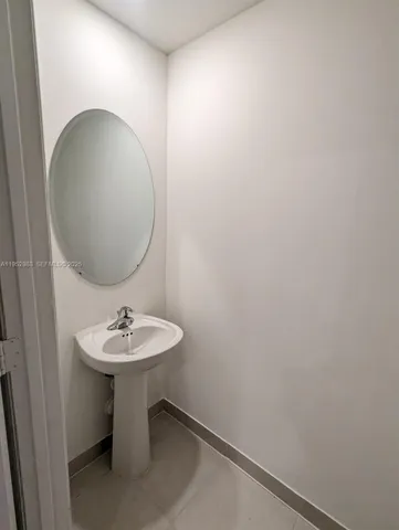 a bathroom with a sink and mirror
