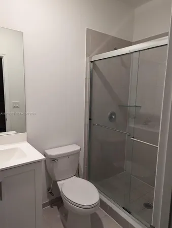 a white toilet sitting next to a bathroom sink