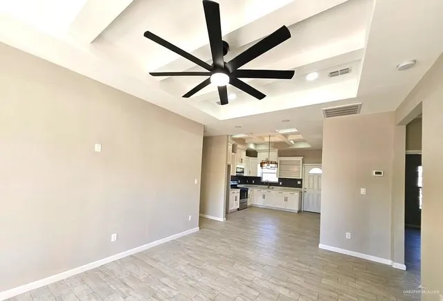 a view of a kitchen with a sink and a refrigerator