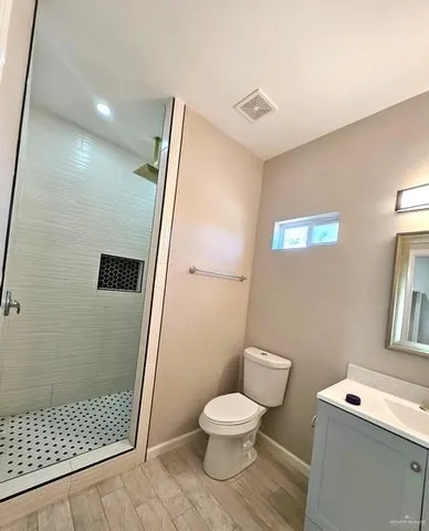 a bathroom with a toilet and a shower
