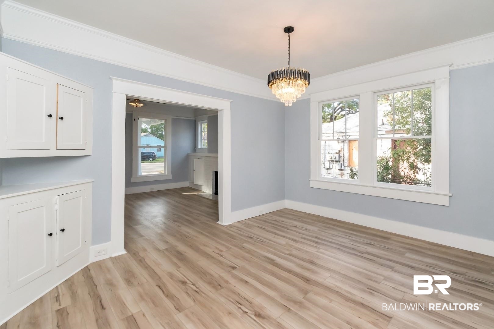555 Michigan Avenue Mobile, AL 36604 - Photo 9 of 28 Unfurnished dining area featuring light hardwood / wood-style floors, a notable chandelier, and crown molding