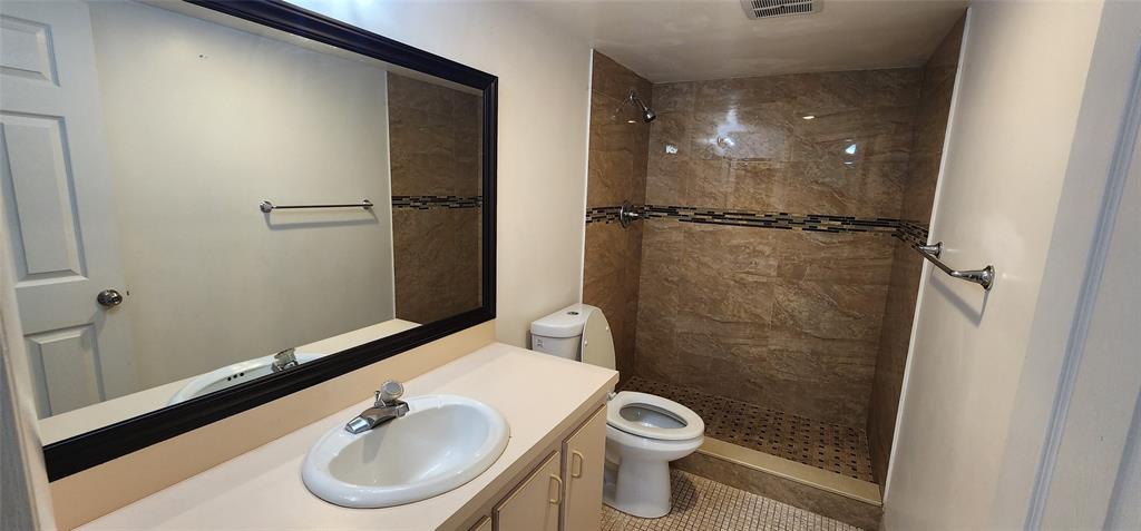 4168 Inverrary Drive, Unit 401 Lauderhill, FL 33319 - Photo 13 of 22 a bathroom with a sink and a mirror