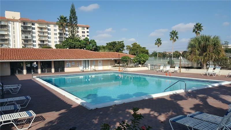 4168 Inverrary Drive, Unit 401 Lauderhill, FL 33319 - Photo 20 of 22 a view of a swimming pool with a patio