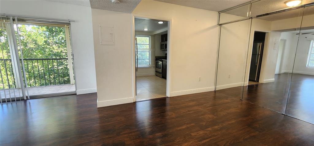 4168 Inverrary Drive, Unit 401 Lauderhill, FL 33319 - Photo 4 of 22 an empty room with wooden floor and windows