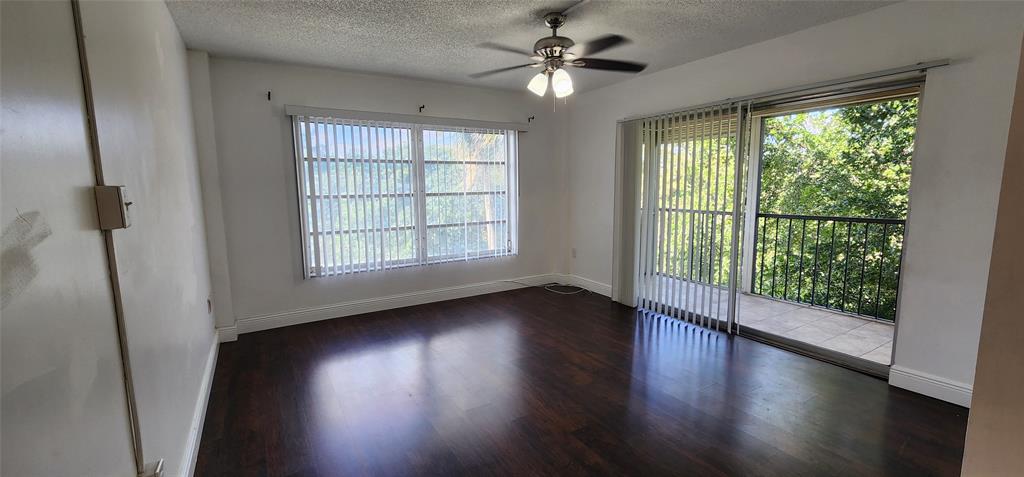 4168 Inverrary Drive, Unit 401 Lauderhill, FL 33319 - Photo 7 of 22 a view of an empty room with wooden floor and a window
