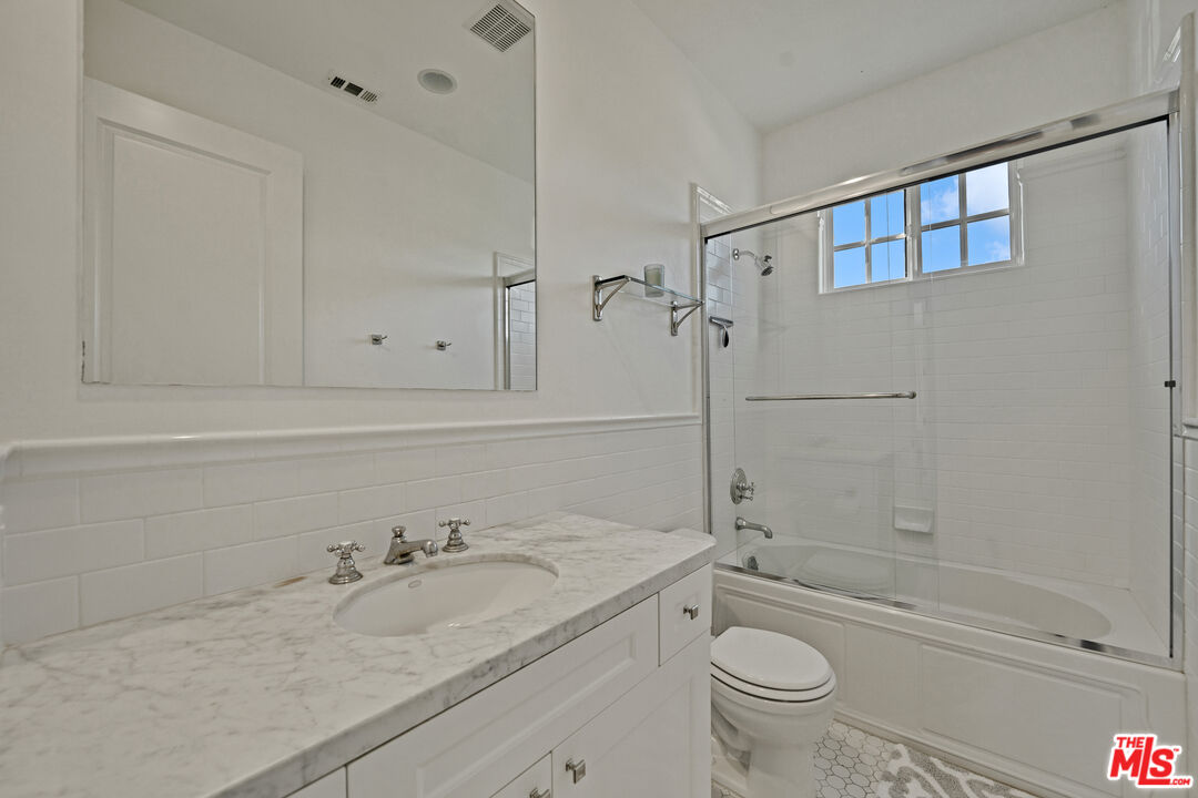 28850 Hampton Place Malibu, CA 90265 - Photo 20 of 58 a bathroom with a granite countertop sink a toilet and shower