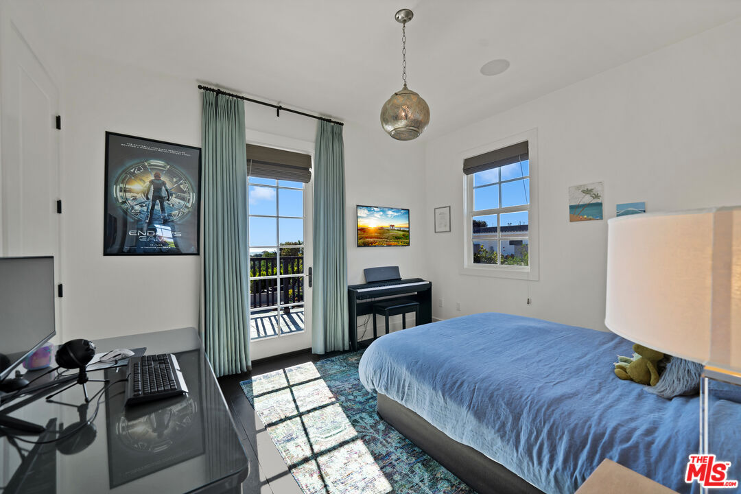 28850 Hampton Place Malibu, CA 90265 - Photo 21 of 58 a bed room with a bed and a chandelier