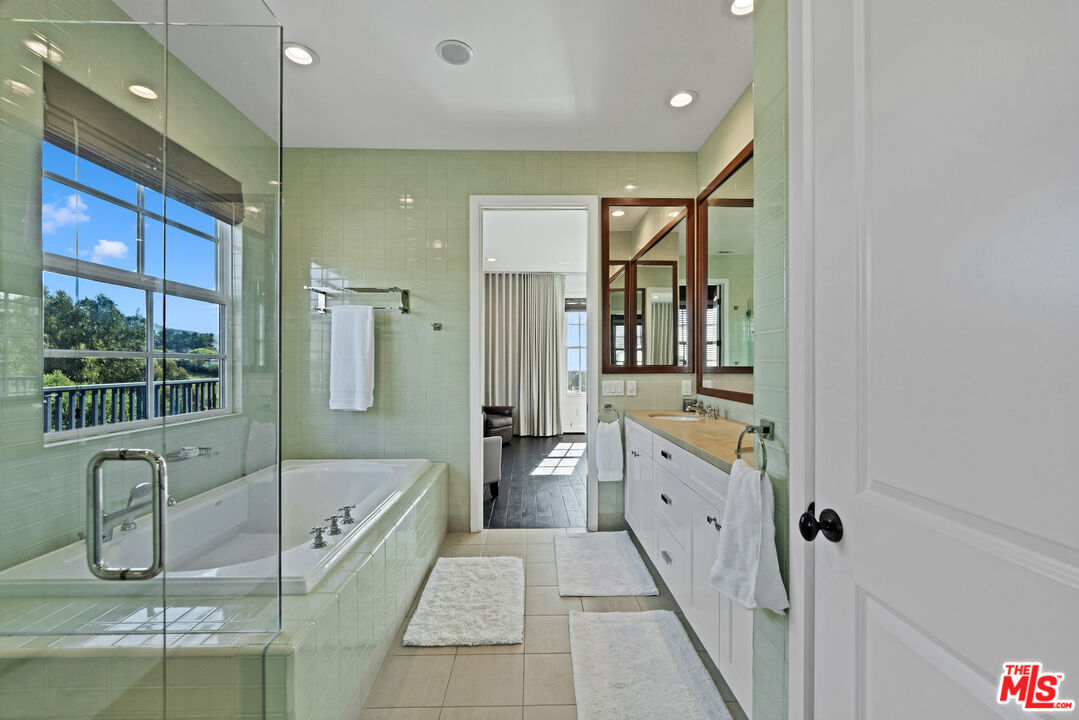 28850 Hampton Place Malibu, CA 90265 - Photo 25 of 58 a bathroom with a tub a sink and mirror