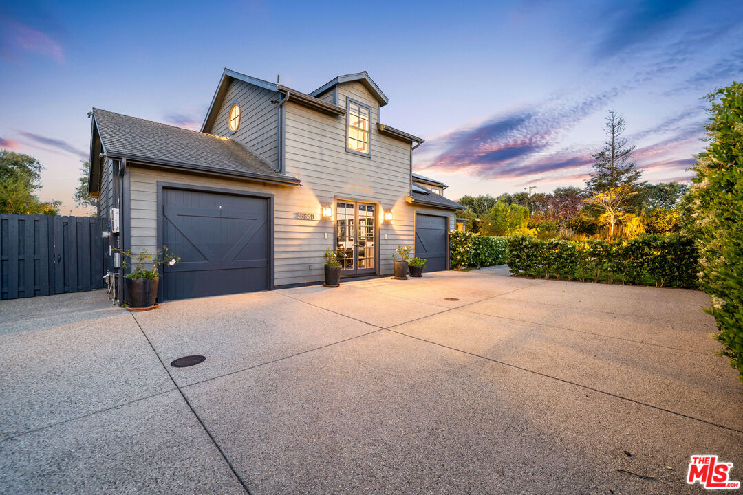 28850 Hampton Place Malibu, CA 90265 - Photo 26 of 58 a front view of a house with a yard and garage