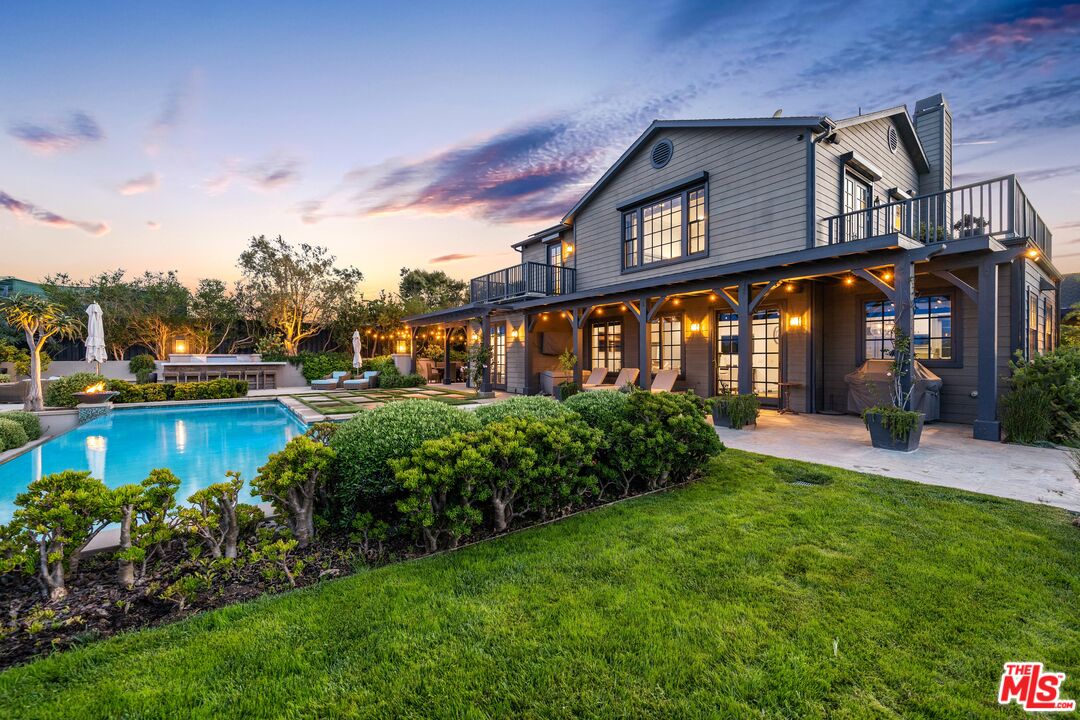 28850 Hampton Place Malibu, CA 90265 - Photo 34 of 58 a front view of a house with a garden and lake view