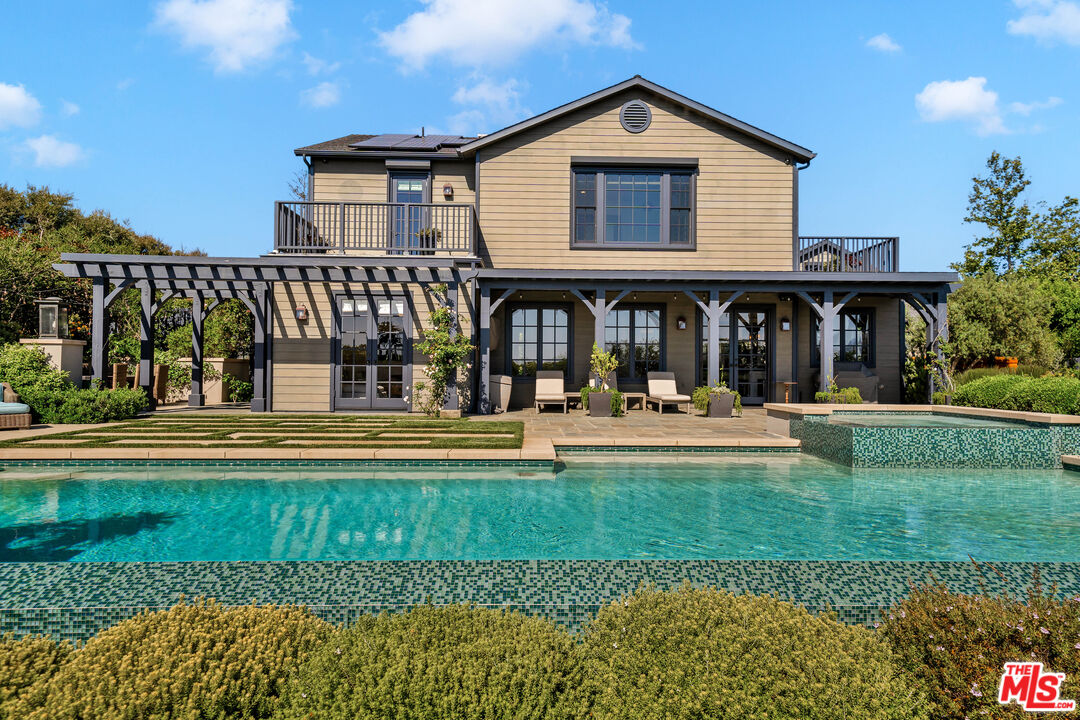 28850 Hampton Place Malibu, CA 90265 - Photo 47 of 58 a view of a house with swimming pool and a yard in front of the house