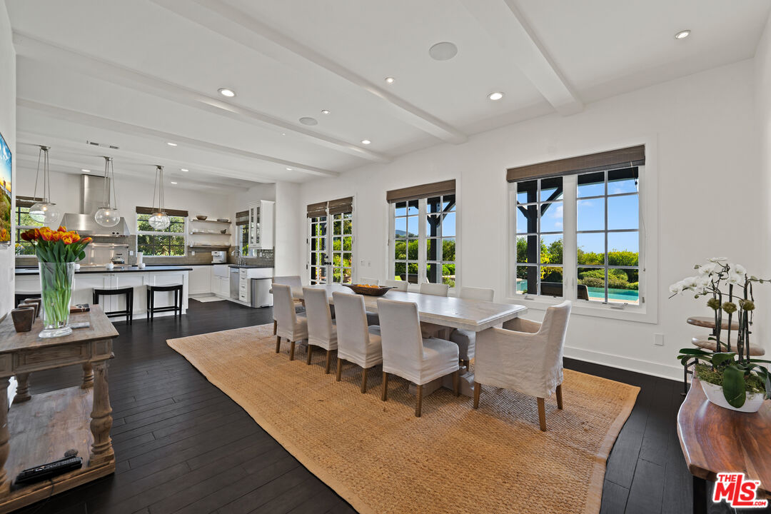 28850 Hampton Place Malibu, CA 90265 - Photo 9 of 58 a living room with furniture dining table and a large window