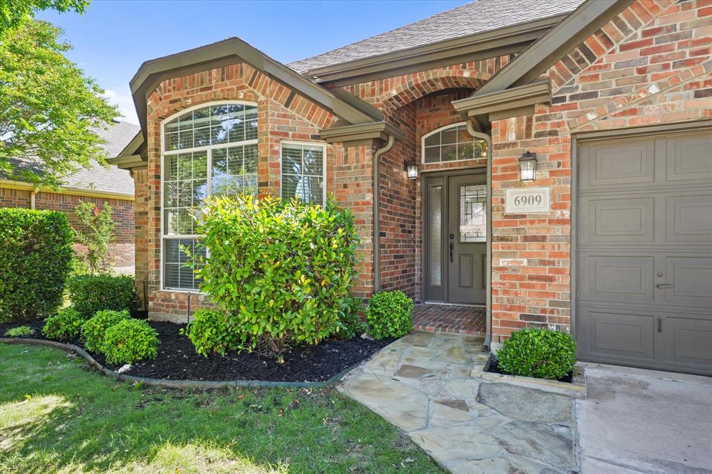 6909 Crenshaw Lane Denton, TX 76210 - Photo 1 of 1 a front view of a house with garden