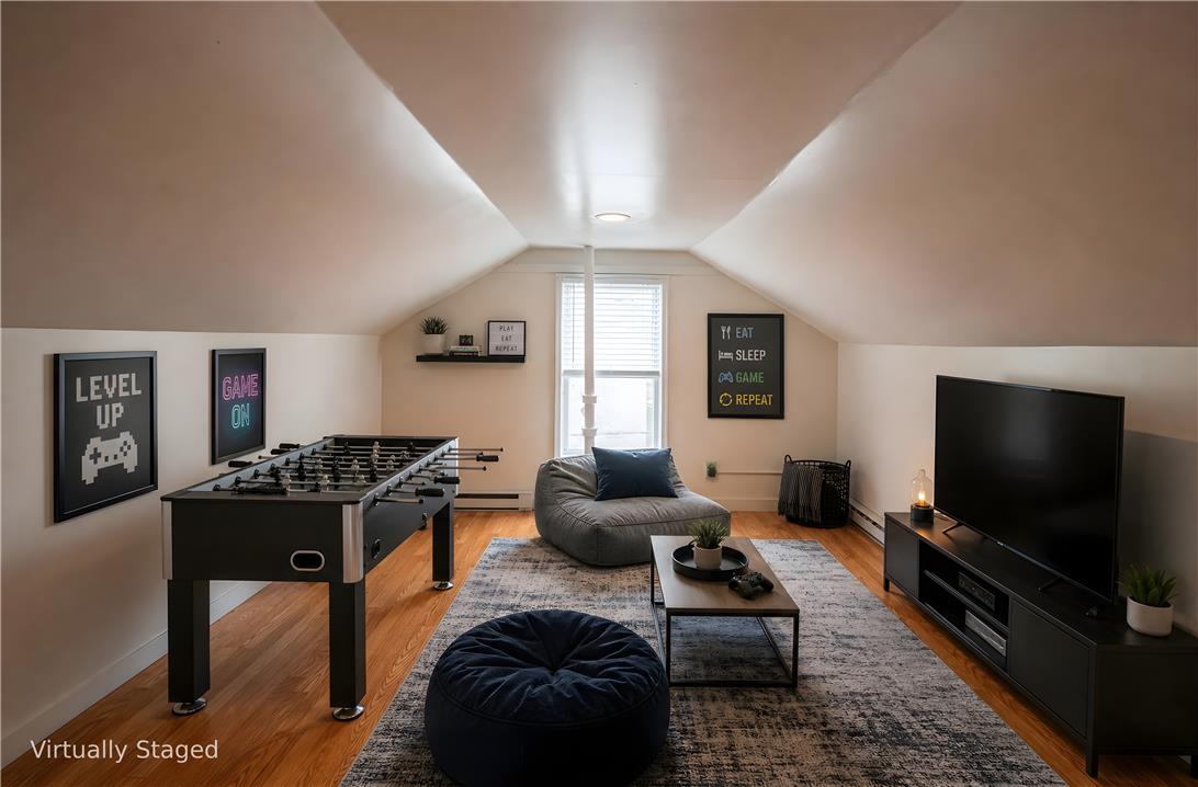 27 West Allen Street Allentown, PA 18102 - Photo 21 of 26 Sloped ceilings and rich hardwood flooring create an inviting atmosphere in this versatile loft space.