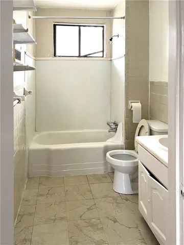 a bathroom with a toilet a sink and a bathtub