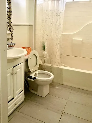 a bathroom with a toilet a sink and a mirror