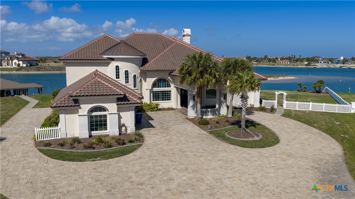 153 Tuscany Way Port O'Connor, TX 77982 - Photo 1 of 48 a front view of a house with garden