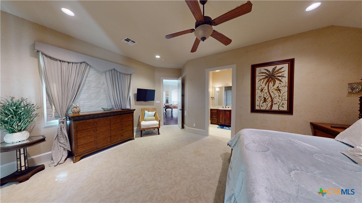153 Tuscany Way Port O'Connor, TX 77982 - Photo 33 of 48 a large bedroom with a bed and furniture