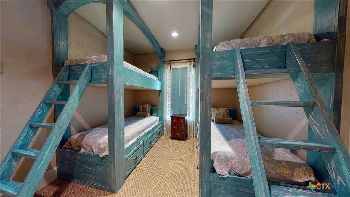 153 Tuscany Way Port O'Connor, TX 77982 - Photo 35 of 48 a bedroom with a bed and a mirror