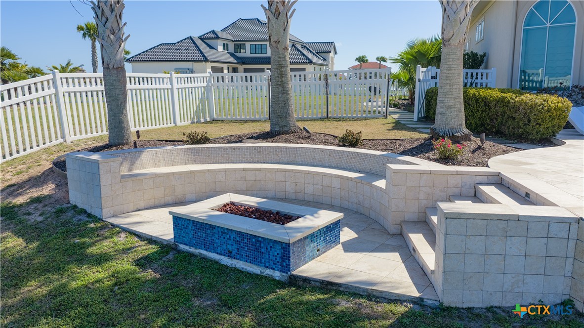 153 Tuscany Way Port O'Connor, TX 77982 - Photo 41 of 48 a backyard of a house with table and chairs