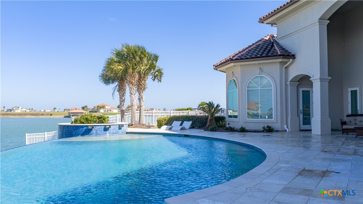 153 Tuscany Way Port O'Connor, TX 77982 - Photo 42 of 48 a view of a house with swimming pool and sitting area