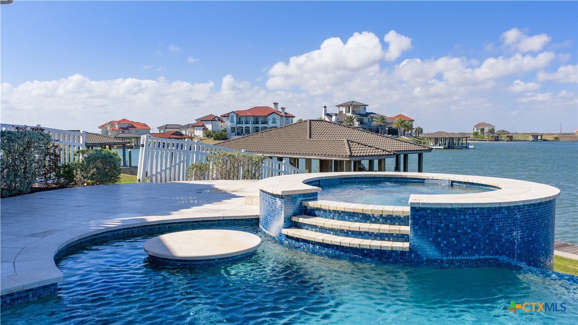 153 Tuscany Way Port O'Connor, TX 77982 - Photo 43 of 48 a view of a house with pool and a yard