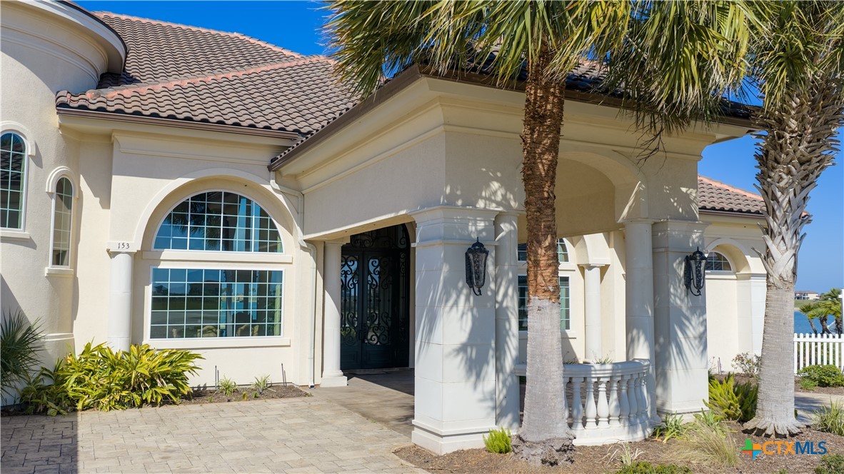 153 Tuscany Way Port O'Connor, TX 77982 - Photo 5 of 48 a front view of a house with a garden