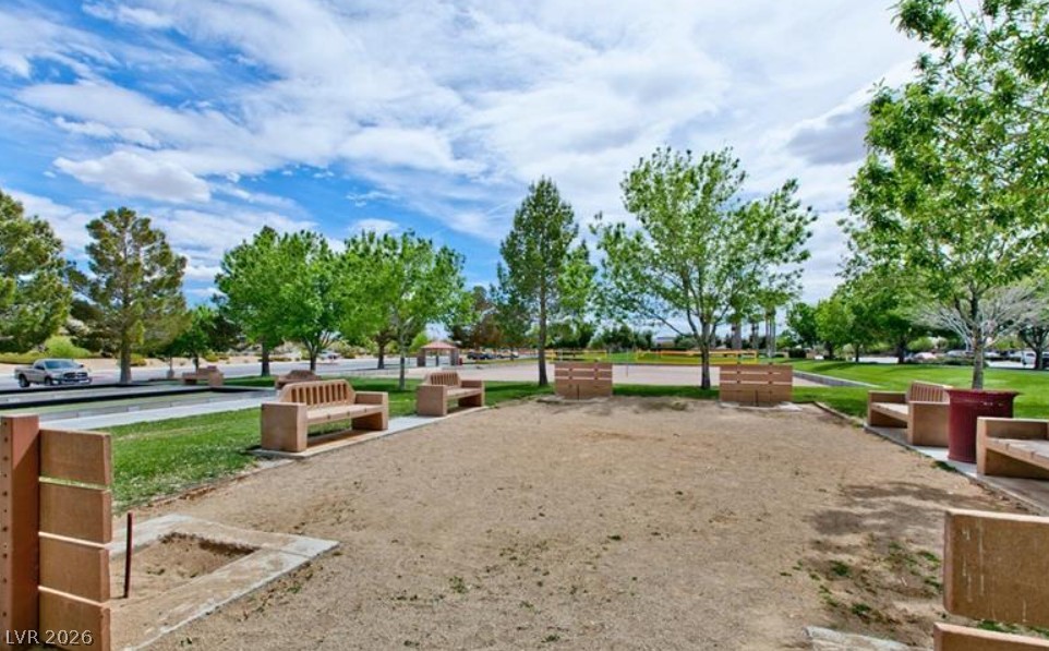 6405 North Raptor Court North Las Vegas, NV 89084 - Photo 60 of 66 An inviting community space offers outdoor recreation and comfortable seating amidst green landscaping.