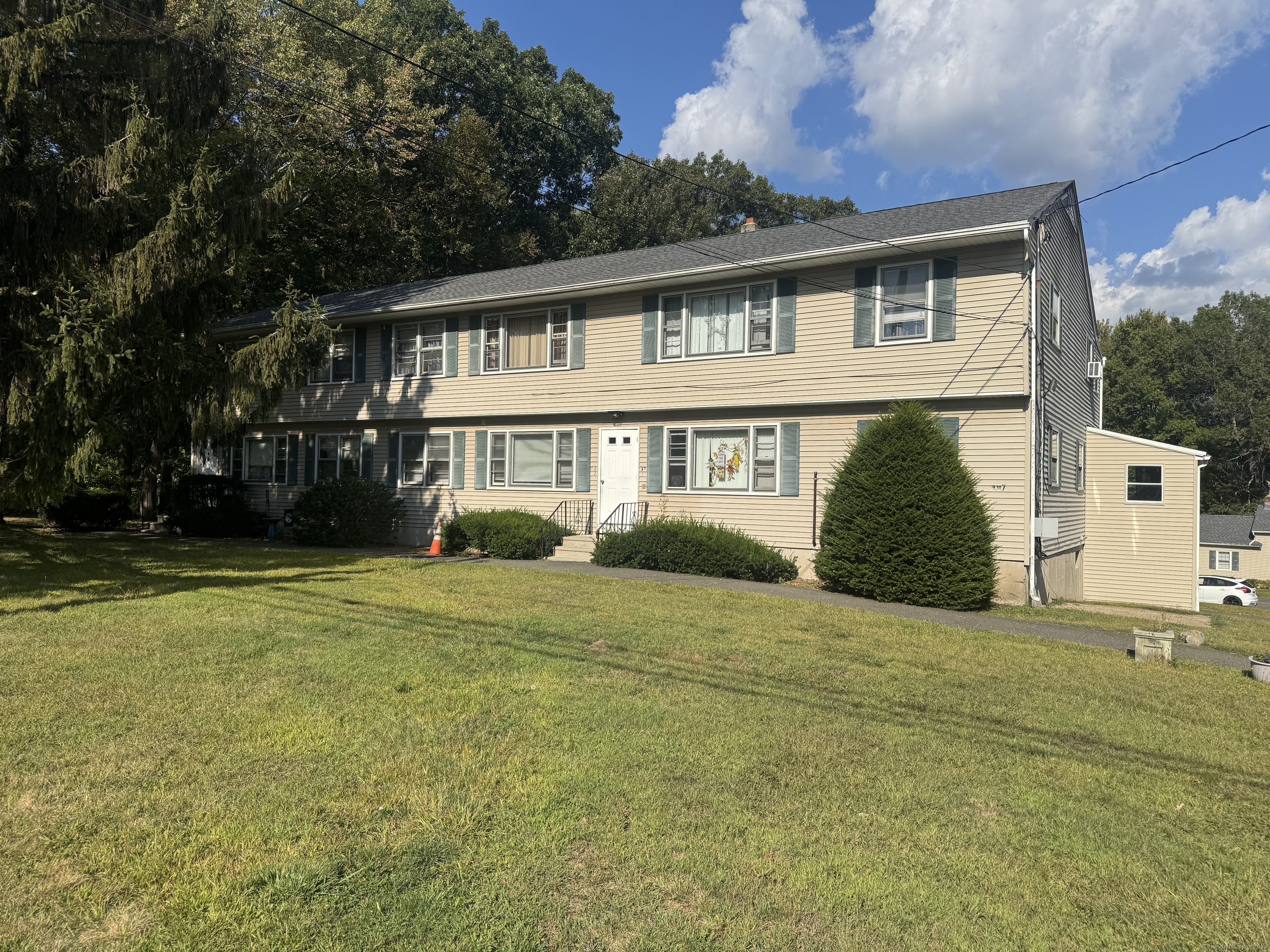 197 Potuccos Ring Road, Unit 5 Wolcott, CT 06716 - Photo 1 of 19 a front view of a house with a garden