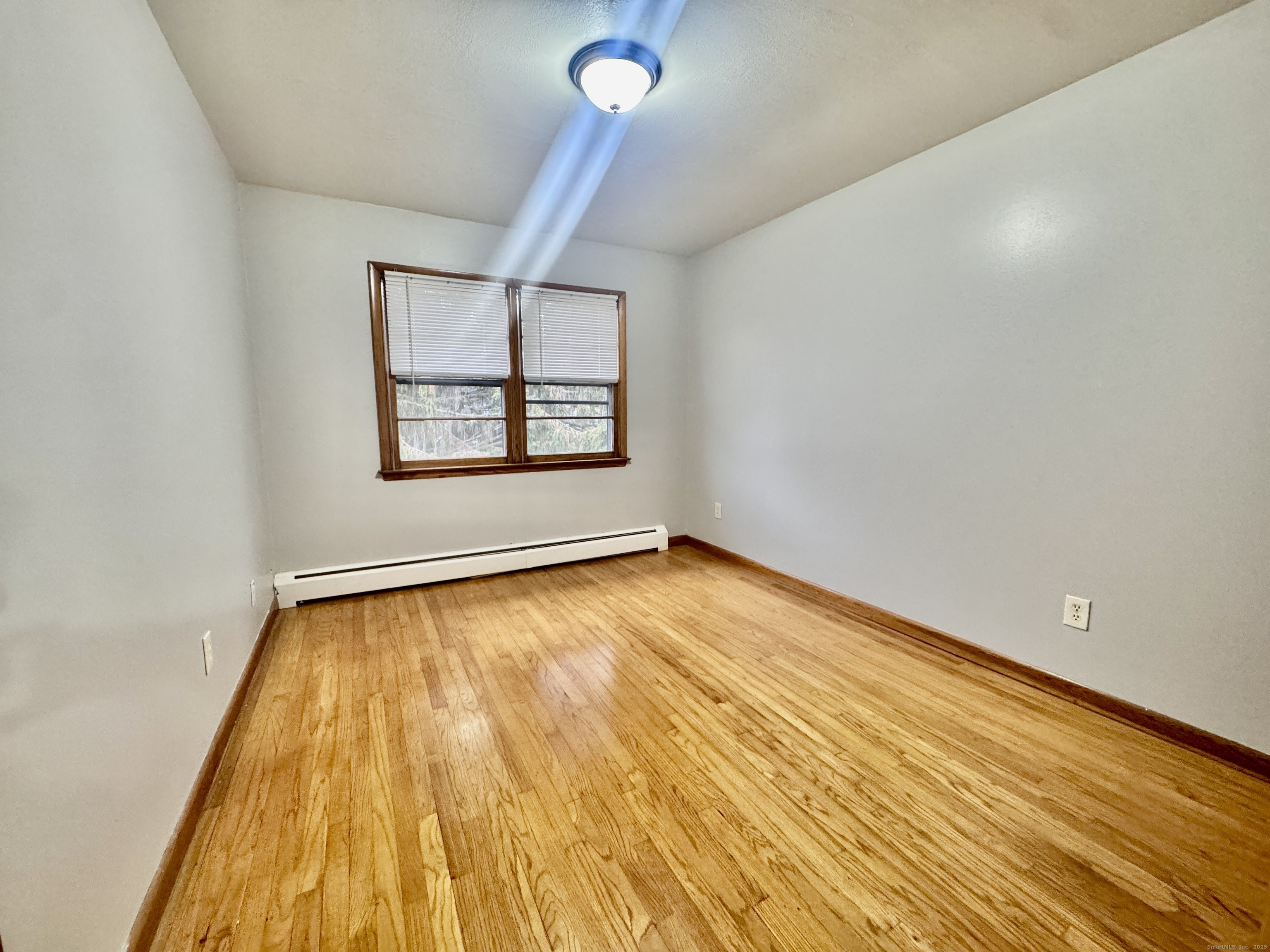 197 Potuccos Ring Road, Unit 5 Wolcott, CT 06716 - Photo 11 of 19 a view of an empty room and window