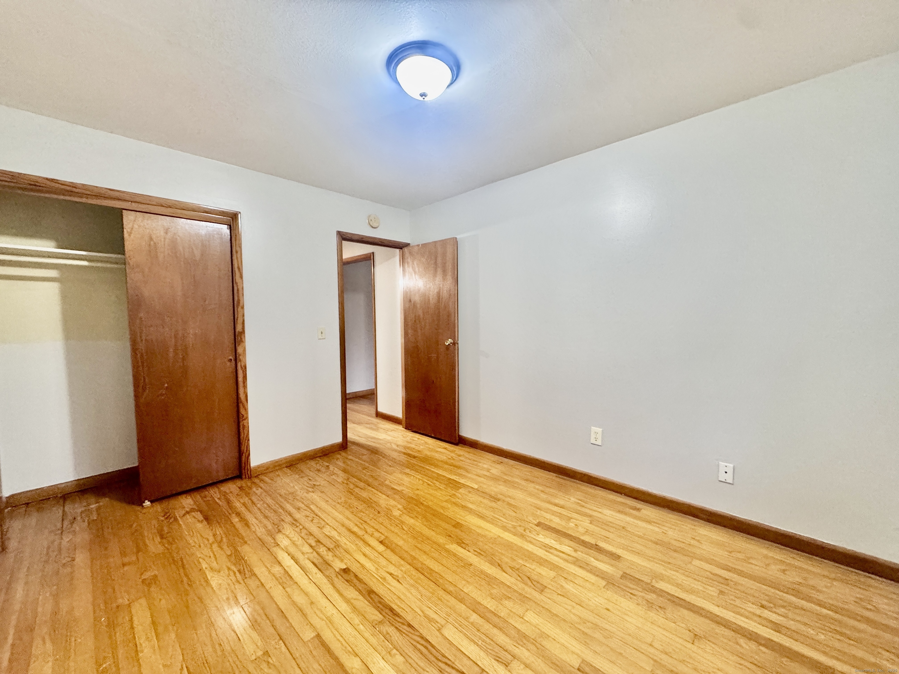 197 Potuccos Ring Road, Unit 5 Wolcott, CT 06716 - Photo 13 of 19 a view of an empty room and wooden floor