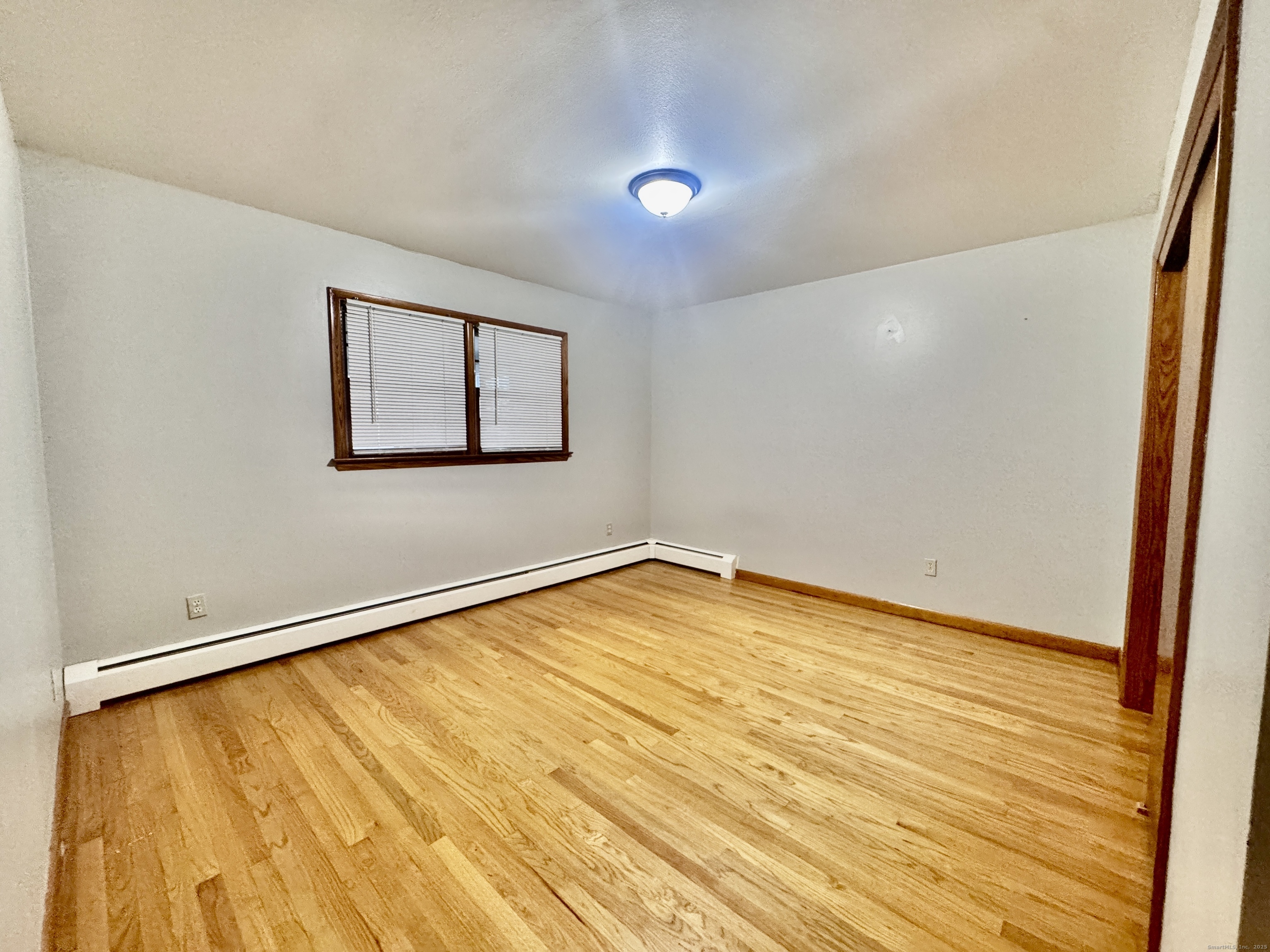 197 Potuccos Ring Road, Unit 5 Wolcott, CT 06716 - Photo 14 of 19 a view of empty room with wooden floor and fan