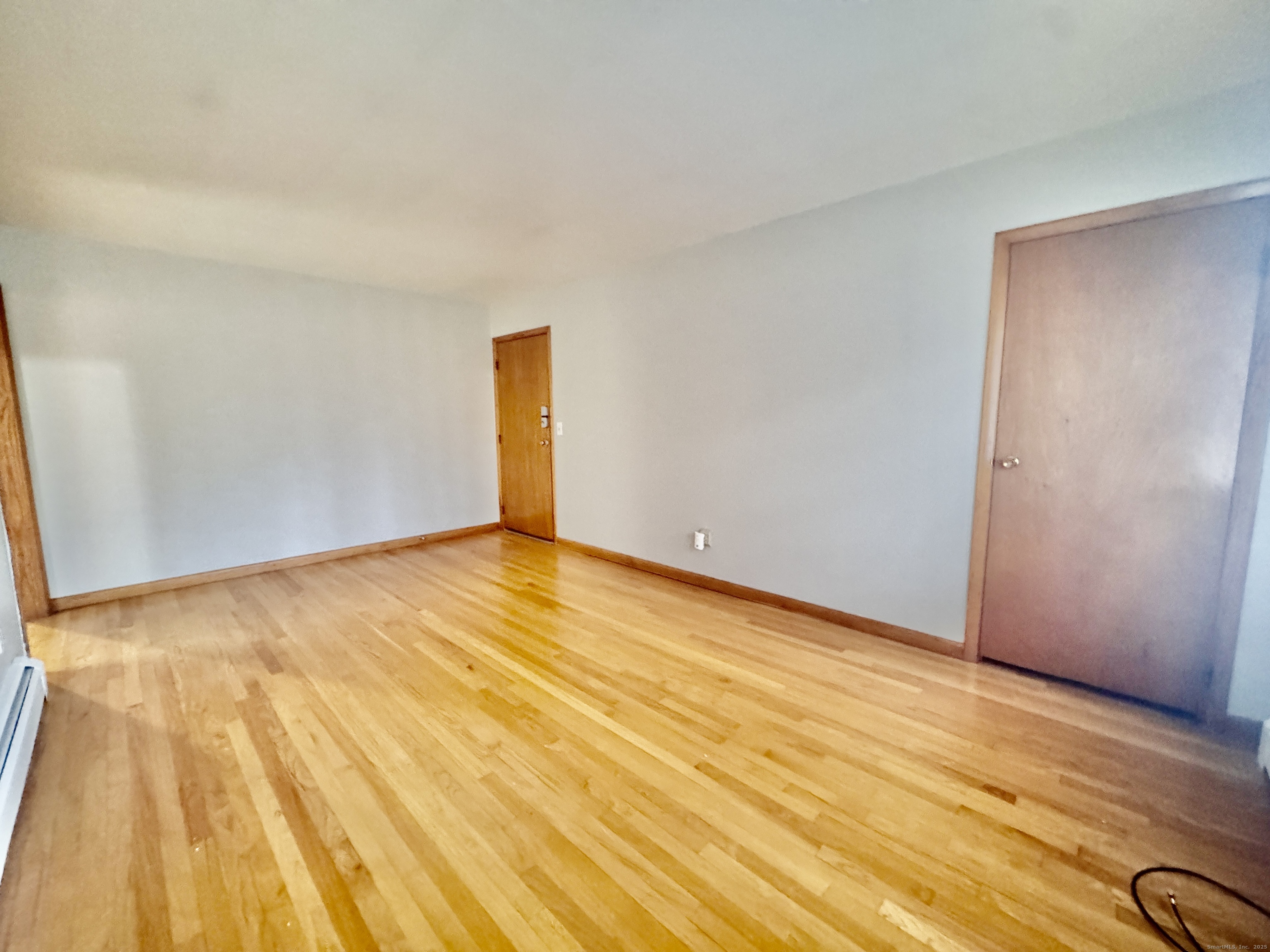 197 Potuccos Ring Road, Unit 5 Wolcott, CT 06716 - Photo 3 of 19 a view of an empty room with wooden floor