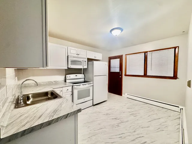 a kitchen with granite countertop a stove and a sink