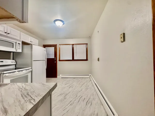 a kitchen with a refrigerator and countertop