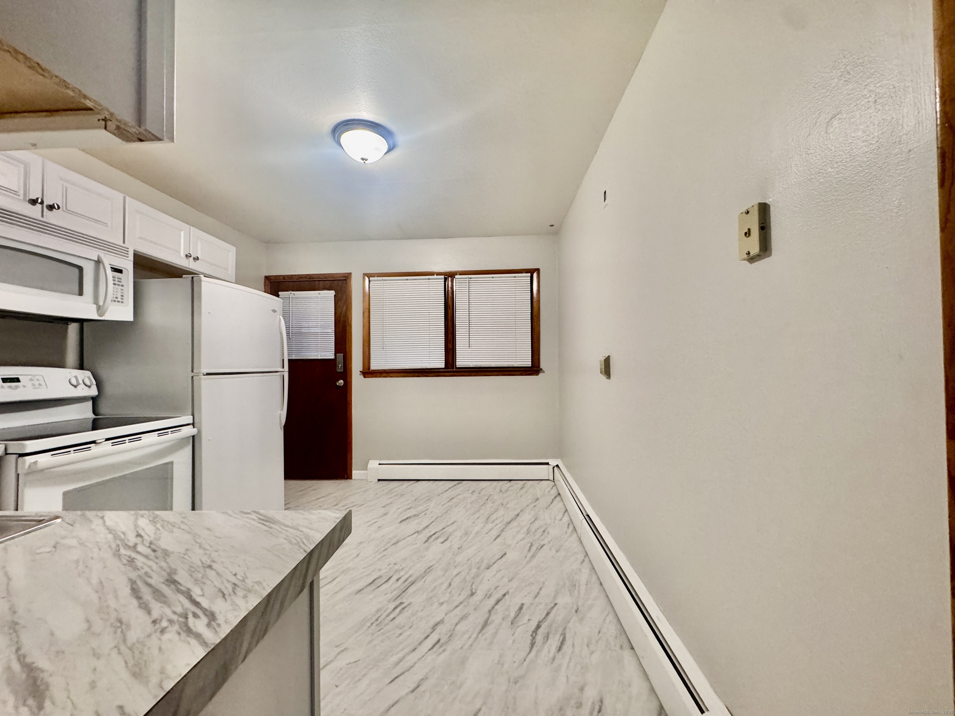 197 Potuccos Ring Road, Unit 5 Wolcott, CT 06716 - Photo 7 of 19 a kitchen with a refrigerator and countertop