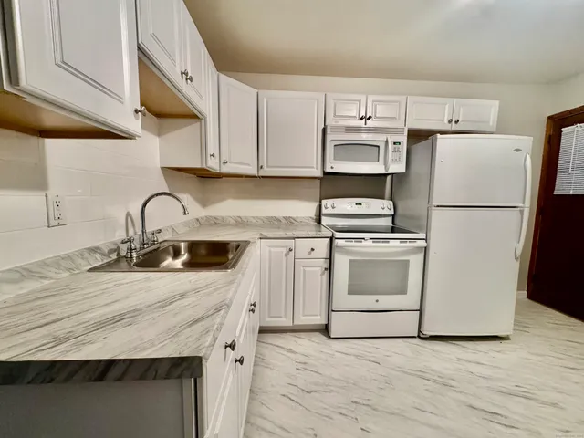 a kitchen with a sink a stove and refrigerator