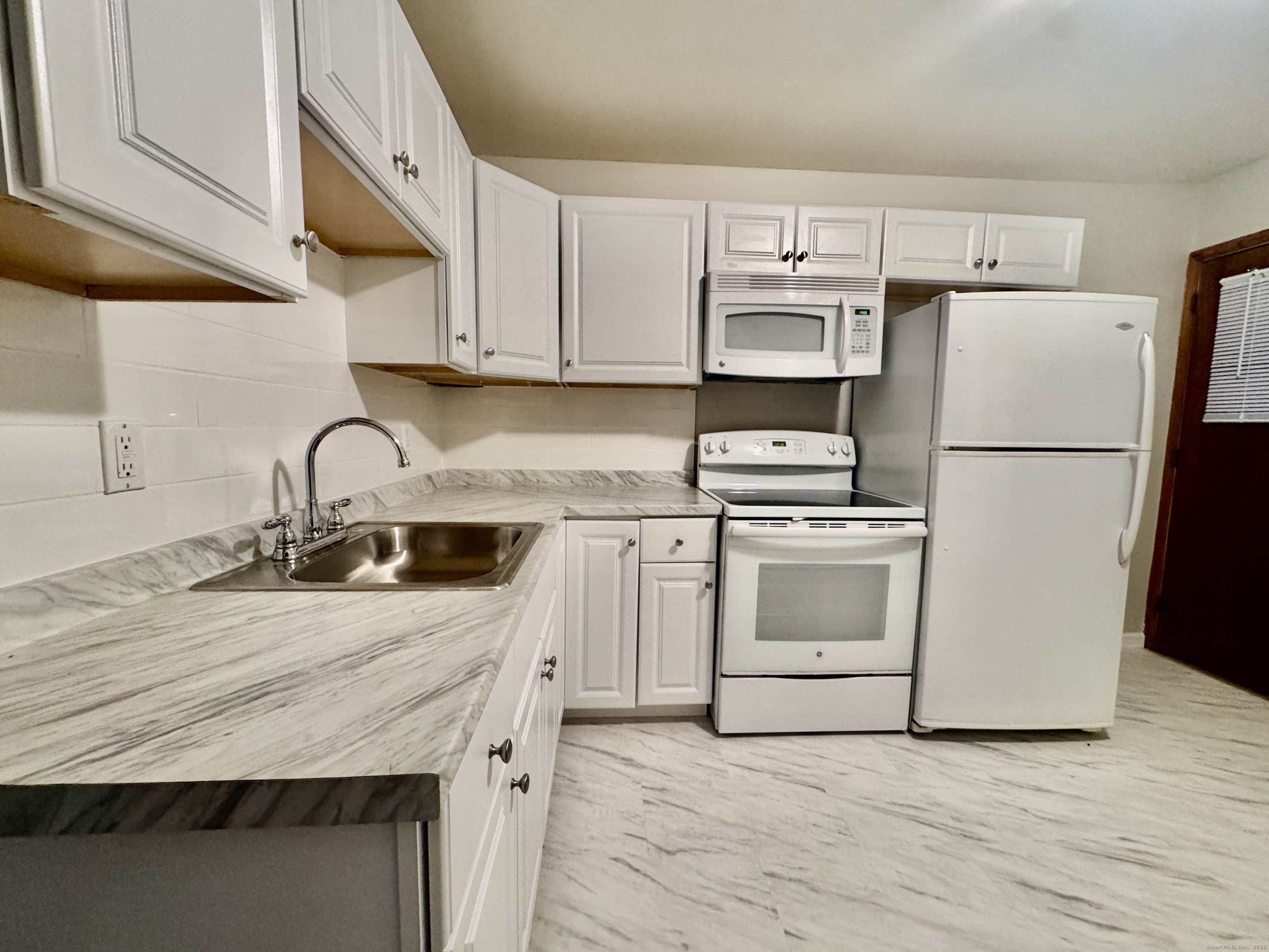 197 Potuccos Ring Road, Unit 5 Wolcott, CT 06716 - Photo 8 of 19 a kitchen with a sink a stove and refrigerator