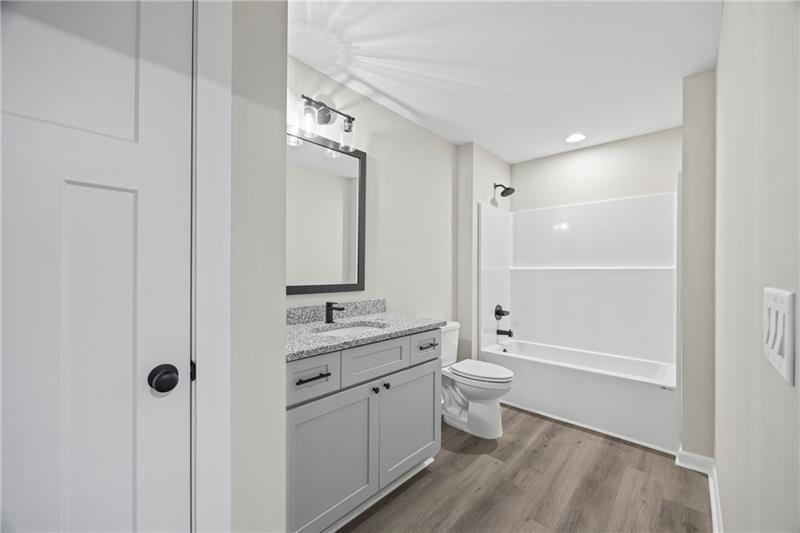 693 Racetrack Road Toccoa, GA 30577 - Photo 38 of 45 a bathroom with a double vanity sink toilet and shower
