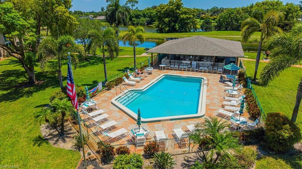 5483 Rattlesnake Hammock Road, Unit B201 Naples, FL 34113 - Photo 3 of 22 an aerial view of a tennis ground and a yard